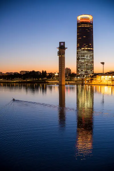 stock image Canoeist on the Guadalquivir river in front of Schindler and Sevilla towers, Seville, Spain.