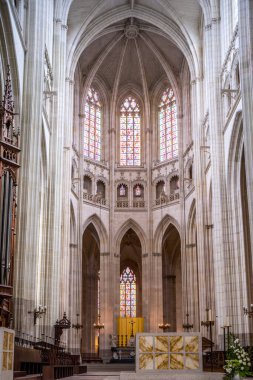 Beautiful interior view of Saint Pierre et Saint Paul Cathedral in Nantes, France, showcasing Gothic architecture and stained glass windows. clipart