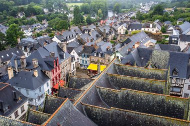 Aerial view of Josselin in Brittany, France showcasing historic medieval buildings, narrow streets, and lush green surroundings. clipart