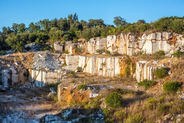 stock image A scenic view of the abandoned marble quarry in Fuenteheridos, Huelva province, Andalusia, Spain. The overgrown vegetation adds a touch of nature to the industrial landscape.