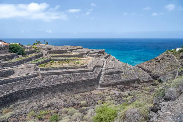 stock image Terraced agricultural fields on volcanic terrain near Bollullo, Tenerife. Overlooking the Atlantic Ocean in the Canary Islands, Spain.