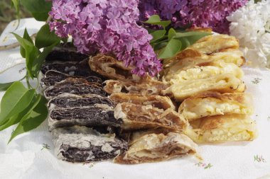 Nicely arranged piles of Hungarian retes (strudel) stuffed with poppy seeds menu, recipe and comfort food concept.
