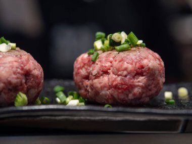 Japon Wagyu köftesi Teppanyaki 'yi pişirmeden önce, üzerine soğan doğranmıştı.,