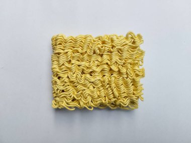 Beyaz arka planda çiğ erişte, para tükendiğinde en çok sevilen yemektir çünkü kolay ve çabuk pişerler..