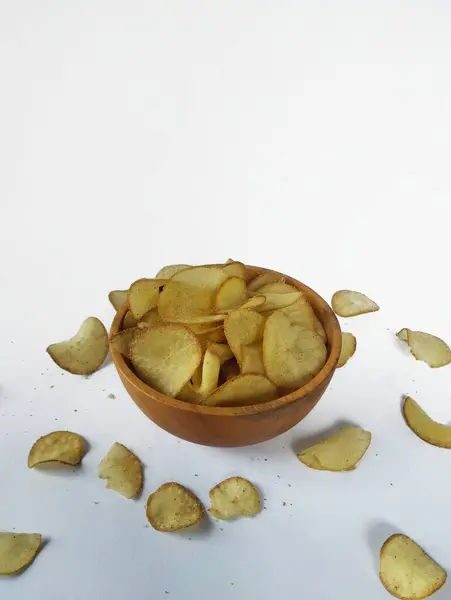 stock image Cassava chips in a wooden bowl with a white background.