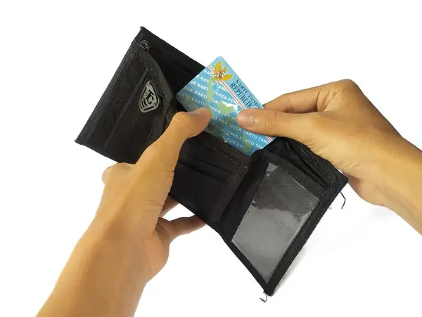 stock image Human hand holding an Indonesian identity card or KTP, isolated on a white background