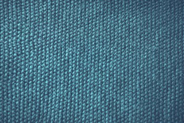 Teal mavisi retro rahat örgü yün süveter arka planı. Yumuşak yün doku. Kusursuz örülmüş kumaş. Kırsal doğal iplik kumaşı. Düz yüzeyin üst görüntüsü. Kış konforu kopyalama alanı.