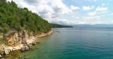 beaches and emerald sea surface, touristic paradise, drone overhead footage