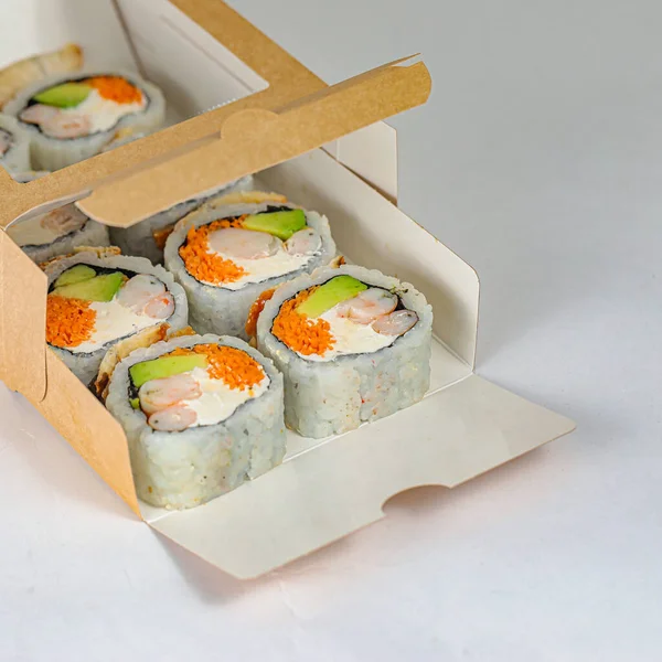 A photo of a sushi box containing four pieces of sushi, showcasing its variety and freshness.