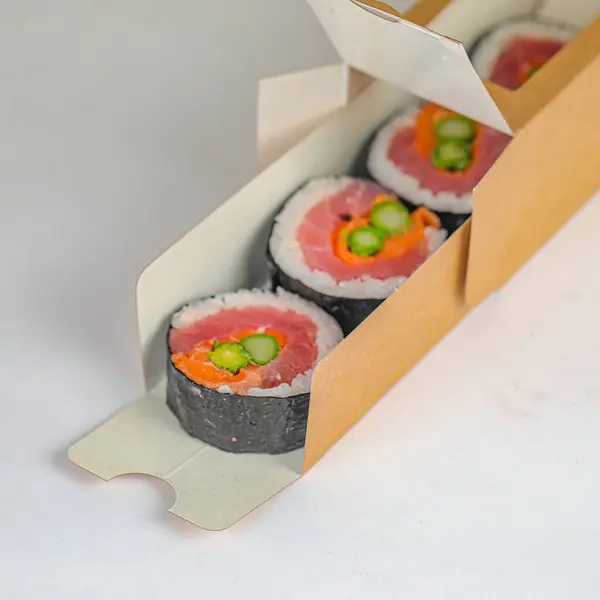 A sushi box containing four distinct sushi pieces made with fresh ingredients.