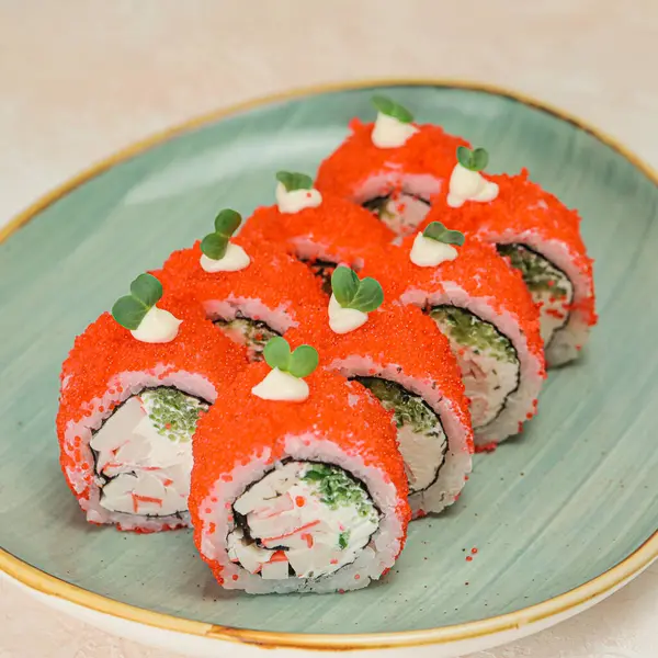 A plate filled with sushi rolls and sashimi sits on a table, ready to be enjoyed.