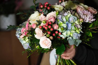 Bir insanın elleri bir demet güzel çiçek tutuyor ve bir sürü kopya alanı var..