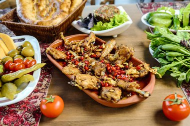 Bir ahşap masa çeşitli mutfaklarla dolu lezzetli yemek kaseleri sergiliyor..