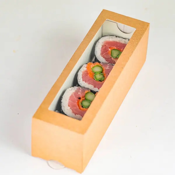 A sushi box filled with fresh cucumbers and tomatoes, ready to be enjoyed.