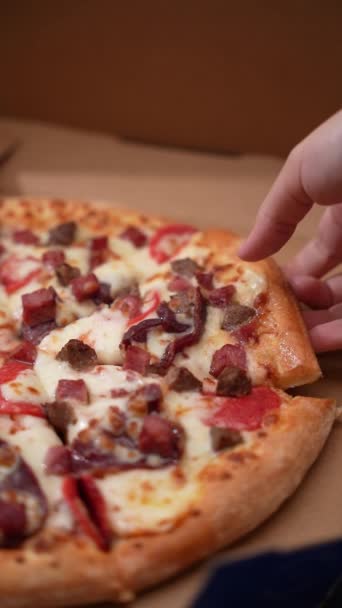 ピザ箱に手を伸ばしてピザのスライスをつかむ人 — ストック動画