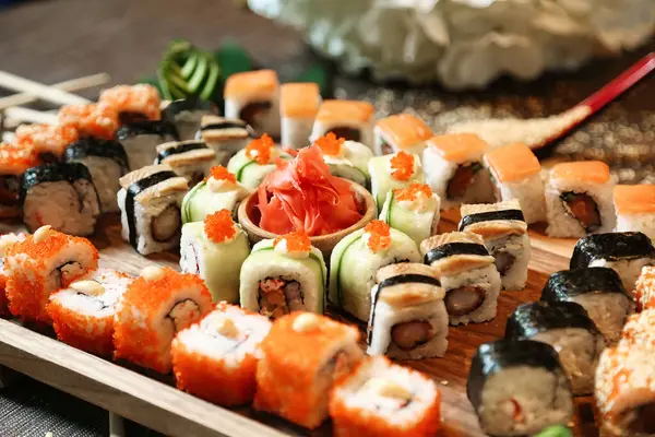 A platter filled with a variety of sushi rolls and nigiri is showcased on a table.