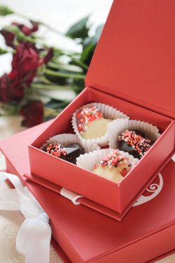 Lezzetli keklerle dolu iki kırmızı kutuyu çeken bir fotoğraf..