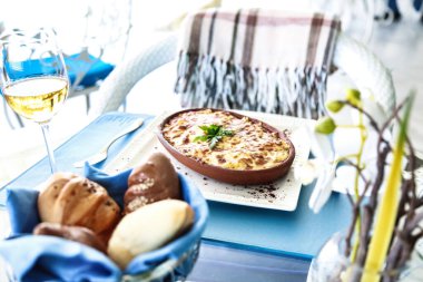 Bir kase yemek ve bir bardak şarapla süslenmiş bir masa..