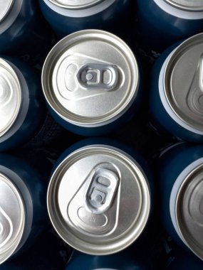 Multiple cans are arranged closely, displaying their silver tops and blue bodies. The image provides a detailed view of the can design and openings. clipart