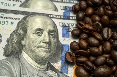 Amerikan para biriminin yanına, kahve kültürü ile günlük yaşamın ekonomik değeri arasındaki bağlantıyı vurgulayan kavrulmuş kahve çekirdekleri koleksiyonu yerleştirilir..