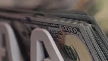 İçinde birkaç yüz dolarlık banknotlar olan bir yığın parayı kapat. Düzenleme, para biriminin dokusunu ve detaylarını net bir ekranda vurgular.