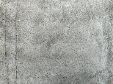 Grunge Scratched Gray Beton Duvarı Arka planı. Tırmalanmış ve yıpranmış beton duvar yüzeyinin pürüzlü gri grunge dokusu. Arka planda, üstüste, inşaat temalarında, kentsel tasarım projelerinde, grunge-style düzenleme ve dijital dokularda kullanım için idealdir.