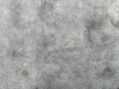 Grunge Scratched Gray Beton Duvarı Arka planı. Tırmalanmış ve yıpranmış beton duvar yüzeyinin pürüzlü gri grunge dokusu. Arka planda, üstüste, inşaat temalarında, kentsel tasarım projelerinde, grunge-style düzenleme ve dijital dokularda kullanım için idealdir.