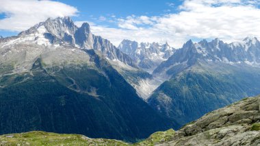 Engebeli tepeleri, yeşil vadileri ve parlak mavi gökyüzü ile görkemli bir dağ sırası Alpler 'de nefes kesici bir doğal manzara yaratıyor.