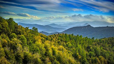 Corsican mountains and dramatic clouds in France clipart