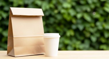 kahve fincanı ve kese kağıdı masada.