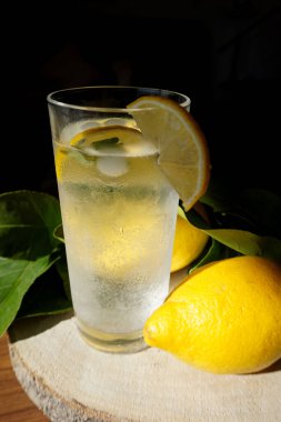 Bir bardak buzlu limonlu, koyu arkaplan buzlu, beyaz limonlu, sağlıklı içecekler. Kokteyl tazeleniyor