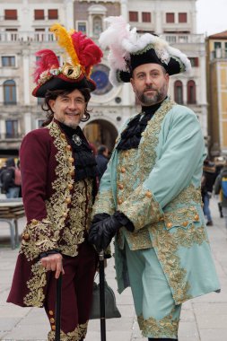 Venice, Italy, February 05th, 2023: A couple of men in traditional costumes during the Venice Carnival.  The Carnival of Venice (Carnevale di Venezia) is an annual festival, held in Venice, Italy and is now established as one of the world s most colo