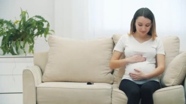 4k slowmotion video of pregnant woman touching her stomach. Concept of pregnant woman.