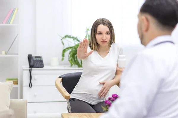 Photo of pregnant woman reaching out to doctor. Concept of visiting to doctor .