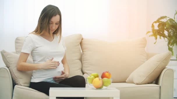 Slowmotion Video Pregnant Woman Sitting White Sofa Smiling Concept Pregnant — Stockvideo