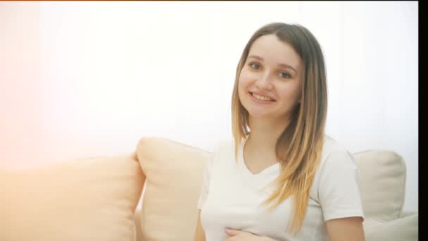 Slowmotion Video Smiling Pregnant Woman Sitting White Sofa Concept Pregnant — Stockvideo