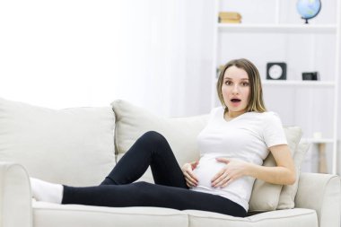 Young pregnant woman looking at the camera. Concept of pregnant woman.