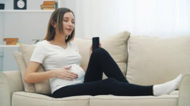 4k slowmotion video of pregnant woman talking over the phone. Concept of pregnant woman.