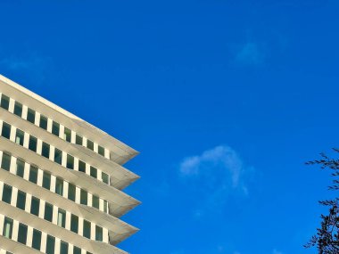 Exterior of tall training building of one of the corporate in france over beautiful blue sky in the background on one sunny day  clipart