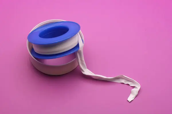 stock image Thread seal tape (plumber's tape) isolated on purple background