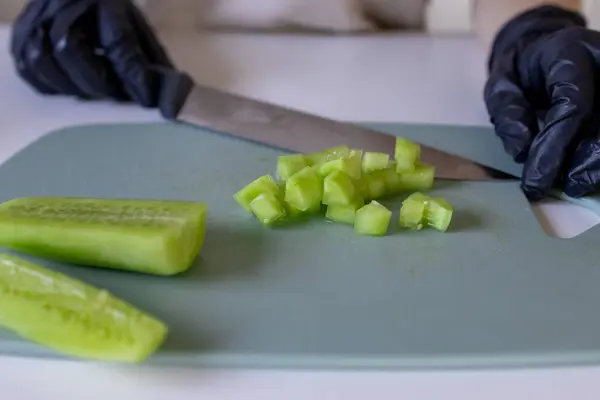 stock image Cutting the cucumber. Peeled cucumber. Small slices of cucumber