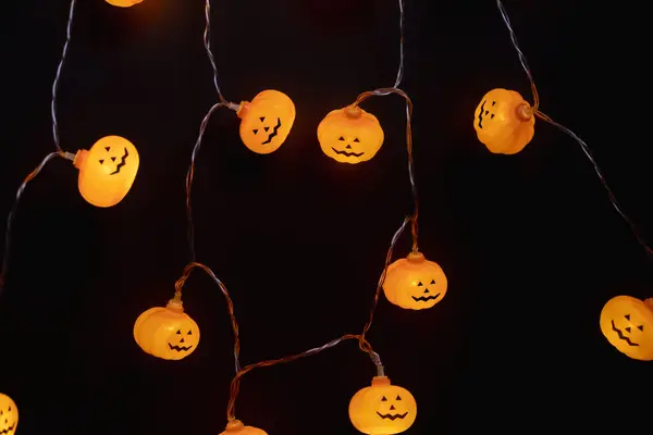 stock image Pumpkin-shaped lanterns on a dark background. Preparing for Halloween