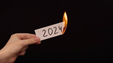 burning a piece of paper with the number 