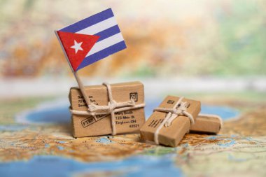 International Shipping and Delivery Services to Cuba: Small Parcels with Cuban Flag on World Map Background clipart