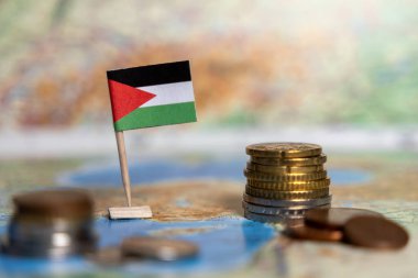 Dünya haritasında istiflenmiş sikkeleri olan Filistin bayrağı ekonomiyi, finansal sistemi ve Filistin ticaretini sembolize ediyor.