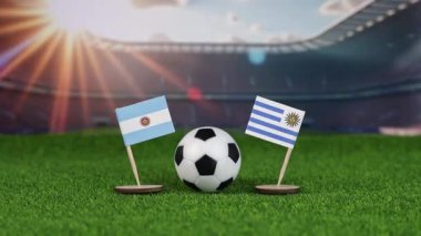 Arjantin, Uruguay 'a karşı milli bayraklarla futbol maçı, yeşil sahada futbol topu ve stadyum arkaplanı tarihi rekabet ve sportmenliği temsil ediyor. yakınlaştır