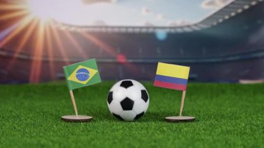 İspanya ve Kolombiya milli bayraklarla futbol maçı, yeşil sahada futbol topu ve stadyum arka planı, uluslararası spor rekabetini ve takım çalışmasını sembolize ediyor. yakınlaştır