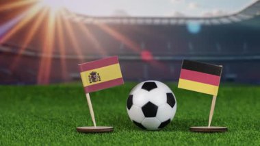 İspanya, Almanya 'ya karşı milli bayraklar, yeşil sahada futbol topu ve bulanık stadyum, Avrupa spor rekabetini ve birliği simgeliyor.