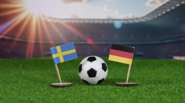 İsveç, Almanya 'ya karşı ulusal bayraklı futbol maçı, yeşil sahada futbol topu ve uluslararası spor rekabetini temsil eden bulanık stadyum. yakınlaştır