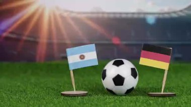 Almanya, Arjantin futboluna karşı milli bayraklar, yeşil sahada futbol topu ve stadyum arka planı dünya kupası tarihini sembolize ediyor.